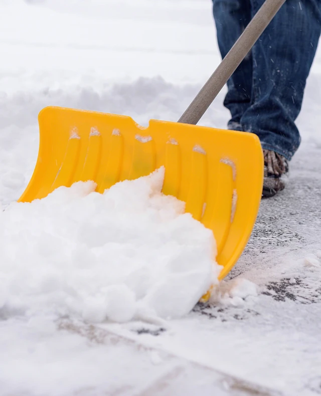 Man shoveling driveway in winter Man shoveling driveway in winter